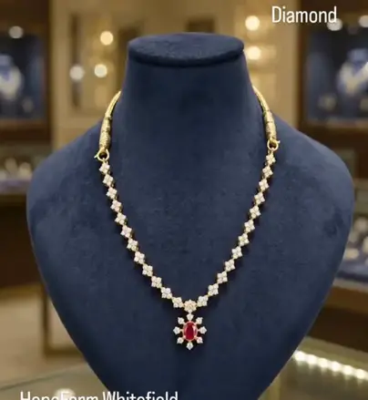 Diamond necklace with red stone drop on a blue velvet bust