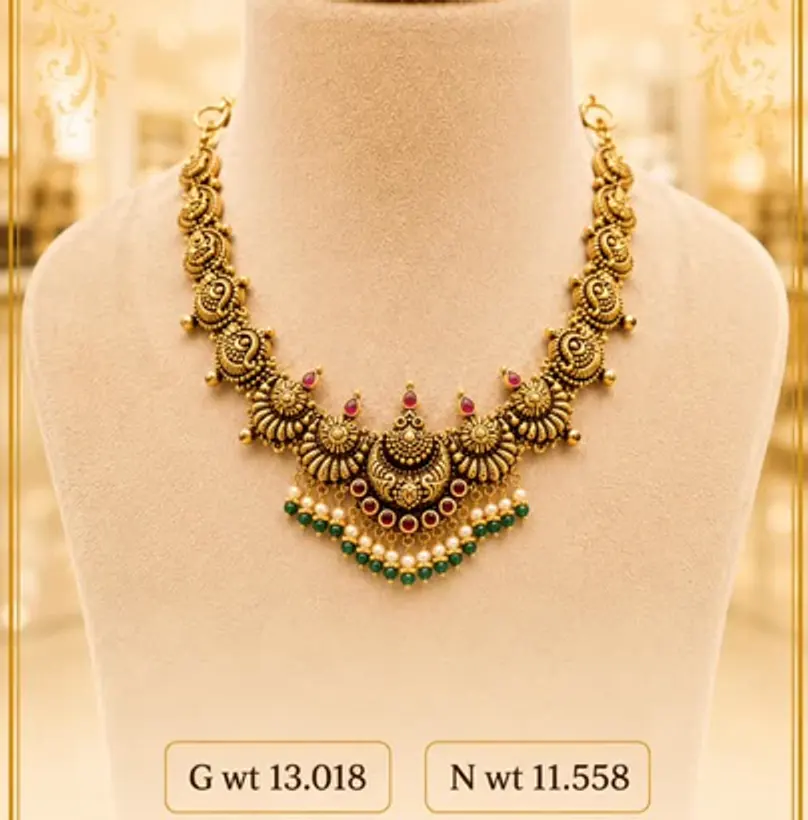 Antique gold necklace on a cream bust with weight chips