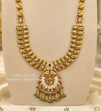 Long temple haram with Lakshmi pendant, pearls and green drops