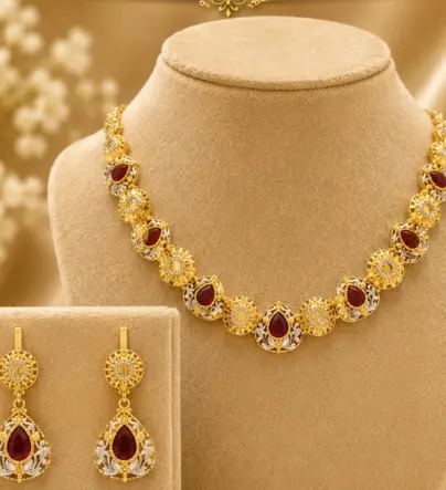 Gold necklace with ruby coloured stones and matching earrings