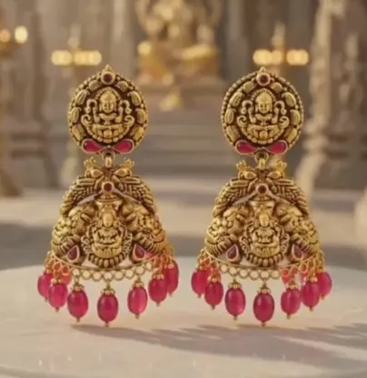 Pair of temple jhumkas with Lakshmi motifs and pink bead drops